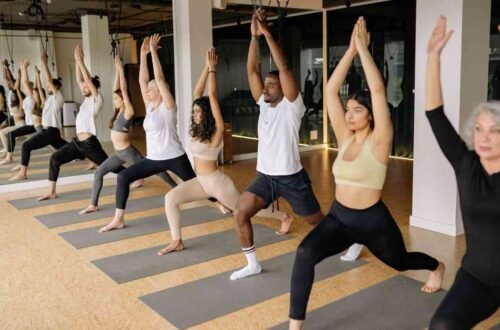 a group of students performing yoga in a class