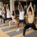 a group of students performing yoga in a class