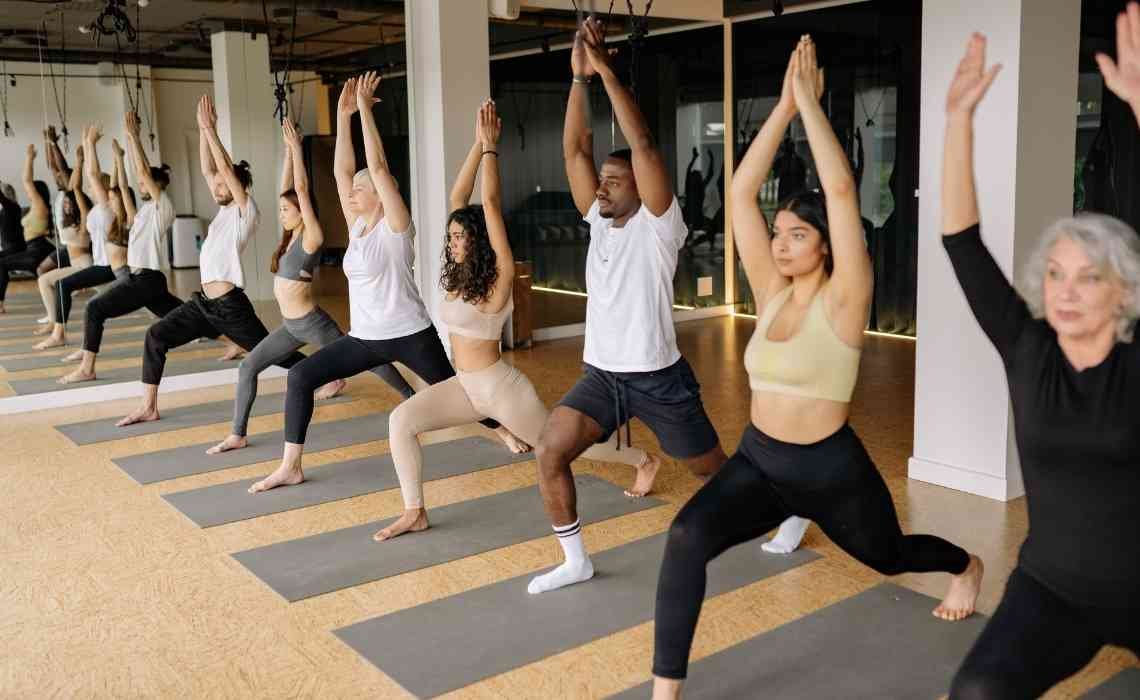 a group of students performing yoga in a class